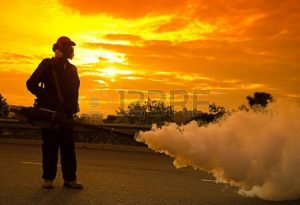 13505877-environmental-health-workers-are-fogging-to-control-dengue-during-sunset